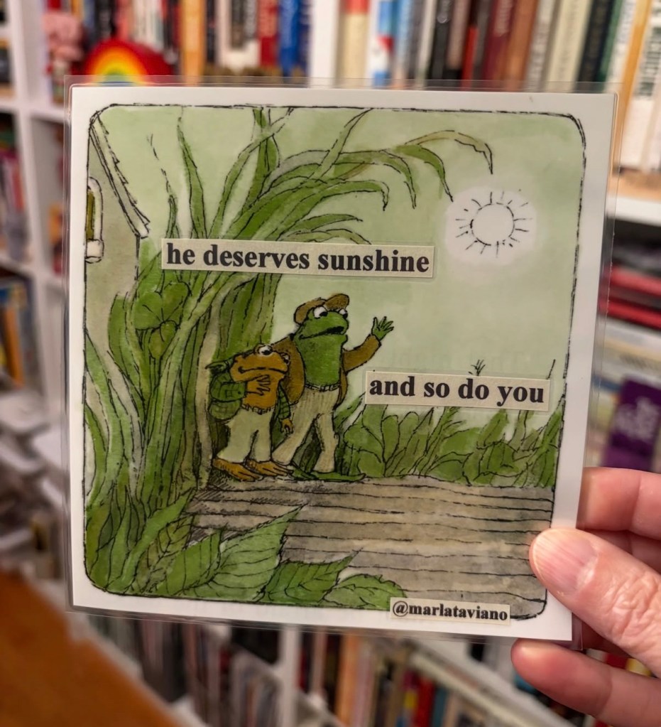 Hand-collaged word art on an illustrated page of a frog and toad standing together on a wooden dock among tall grass and sunshine. The lines "he deserves sunshine" and "and so do you" glued onto the artwork.